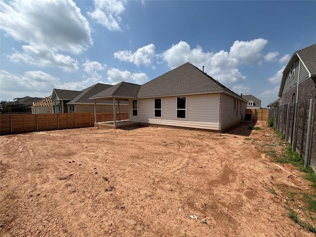 8213 Grenadier Dr, Austin, TX 78738 - back of house featuring a fenced backyard and a patio