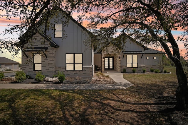 308 Somerset Hills Dr, Georgetown, TX 78633 - modern farmhouse with french doors, board and batten siding, and a lawn