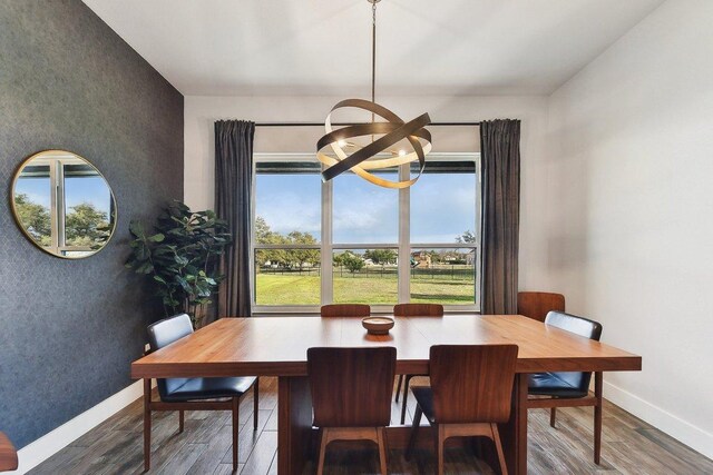 308 Somerset Hills Dr, Georgetown, TX 78633 - dining space featuring a chandelier, wood finished floors, and an accent wall