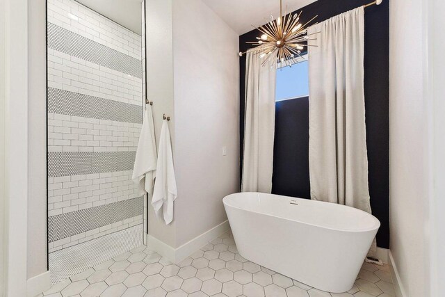 308 Somerset Hills Dr, Georgetown, TX 78633 - full bath with a freestanding tub, tiled shower, a chandelier, and tile patterned flooring