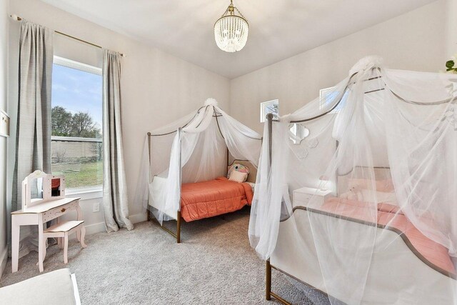308 Somerset Hills Dr, Georgetown, TX 78633 - carpeted bedroom featuring a chandelier and multiple windows