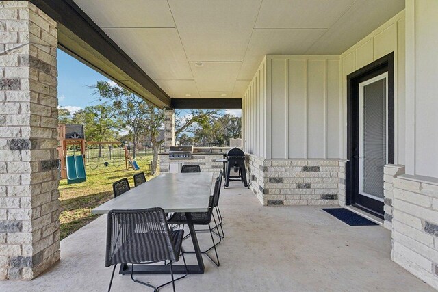 308 Somerset Hills Dr, Georgetown, TX 78633 - view of patio featuring a playground, outdoor dining area, and an outdoor kitchen