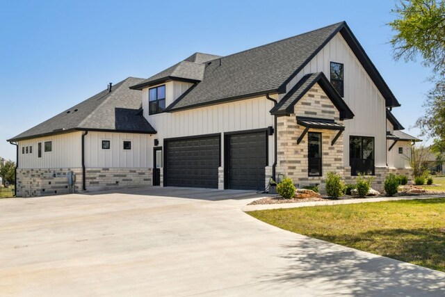 308 Somerset Hills Dr, Georgetown, TX 78633 - modern farmhouse style home with roof with shingles, an attached garage, driveway, board and batten siding, and a front lawn