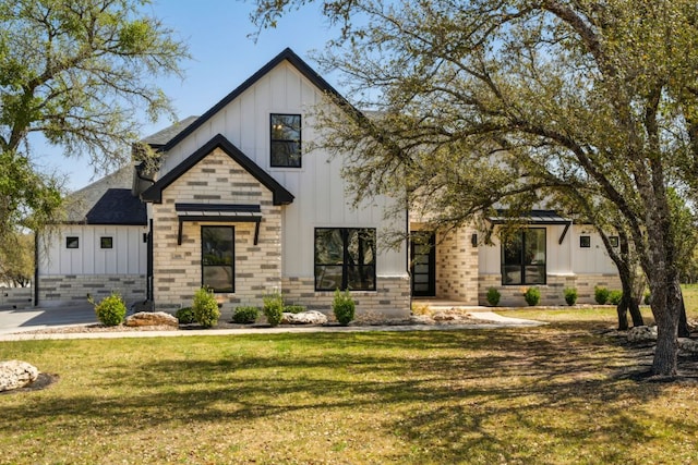 308 Somerset Hills Dr, Georgetown, TX 78633 - modern farmhouse style home with board and batten siding, a front yard, roof with shingles, and brick siding
