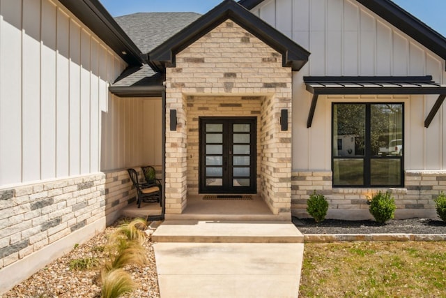 308 Somerset Hills Dr, Georgetown, TX 78633 - view of exterior entry featuring board and batten siding, french doors, stone siding, and roof with shingles