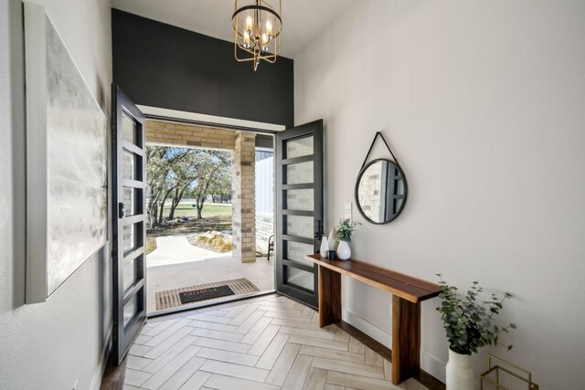 308 Somerset Hills Dr, Georgetown, TX 78633 - entrance foyer with a chandelier, french doors, and a towering ceiling