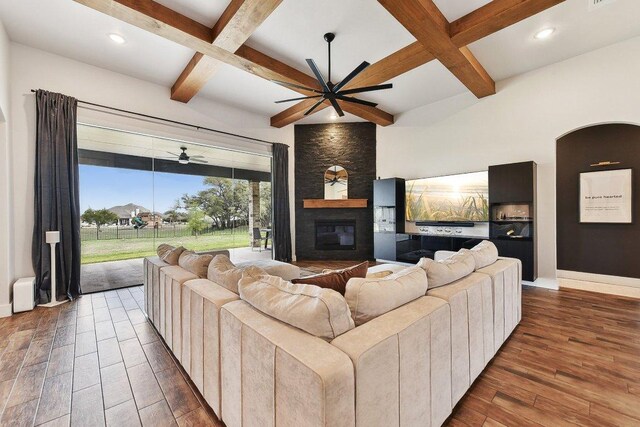 308 Somerset Hills Dr, Georgetown, TX 78633 - living area featuring ceiling fan, coffered ceiling, a large fireplace, wood finished floors, and beamed ceiling