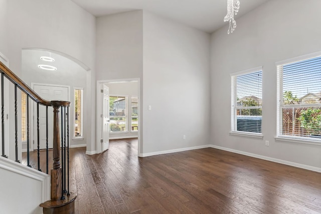 13601 Larrys Ln, Manchaca, TX 78652 - entryway with a notable chandelier, a high ceiling, dark wood-type flooring, and a healthy amount of sunlight