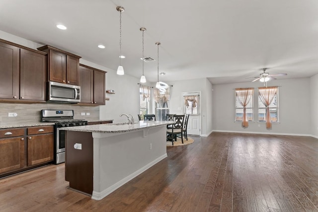 13601 Larrys Ln, Manchaca, TX 78652 - kitchen featuring stainless steel appliances, a sink, an island with sink, healthy amount of natural light, and recessed lighting