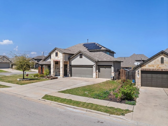 13601 Larrys Ln, Manchaca, TX 78652 - french provincial home with concrete driveway, roof with shingles, fence, stone siding, and solar panels
