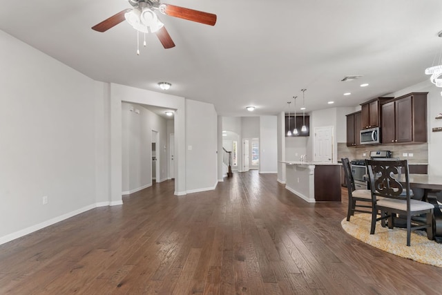 13601 Larrys Ln, Manchaca, TX 78652 - living room featuring baseboards, dark wood-style flooring, visible vents, and a ceiling fan