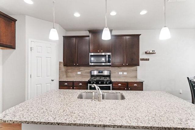13601 Larrys Ln, Manchaca, TX 78652 - kitchen featuring a sink, stainless steel appliances, tasteful backsplash, and dark brown cabinetry