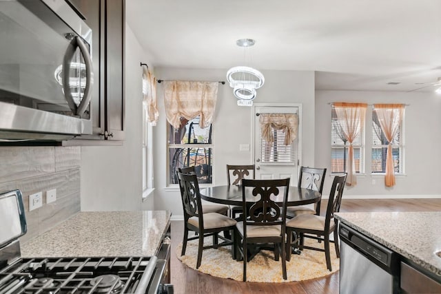 13601 Larrys Ln, Manchaca, TX 78652 - dining area with a notable chandelier, baseboards, and dark wood finished floors