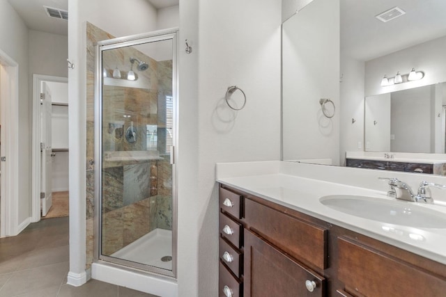 13601 Larrys Ln, Manchaca, TX 78652 - bathroom with visible vents, a stall shower, tile patterned floors, and vanity