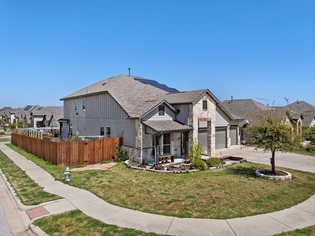 13601 Larrys Ln, Manchaca, TX 78652 - view of front of home featuring stone siding, an attached garage, fence, and a front lawn