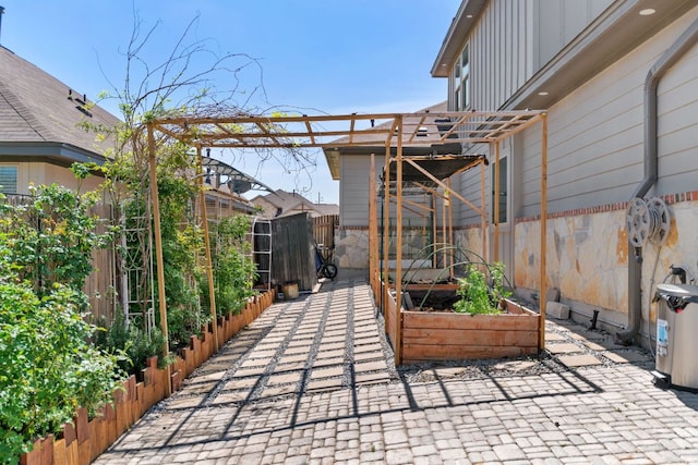 13601 Larrys Ln, Manchaca, TX 78652 - view of patio featuring a pergola, fence, and a garden