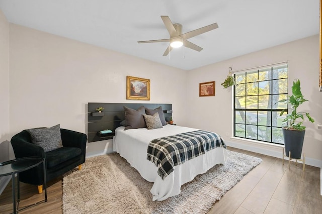11100 Centennial Trl, Austin, TX 78726 - bedroom with light wood-style floors and ceiling fan