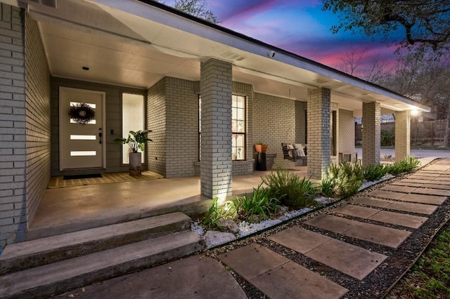 11100 Centennial Trl, Austin, TX 78726 - exterior entry at dusk with brick siding and a porch