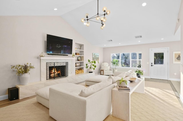 11100 Centennial Trl, Austin, TX 78726 - living room featuring lofted ceiling, built in features, a high end fireplace, a chandelier, and recessed lighting