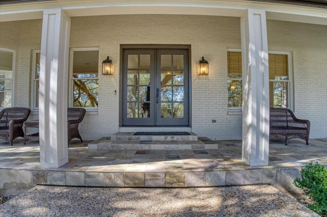 2610 Allston Ln, Austin, TX 78746 - doorway to property with french doors, brick siding, and covered porch