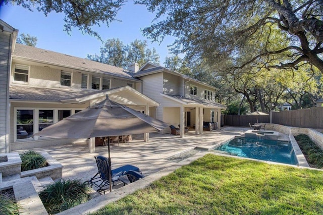 2610 Allston Ln, Austin, TX 78746 - back of house featuring a fenced backyard, a patio area, and a pool with connected hot tub