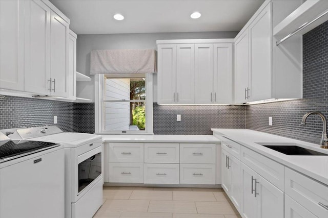 2610 Allston Ln, Austin, TX 78746 - washroom featuring cabinet space, washing machine and dryer, light tile patterned floors, and recessed lighting