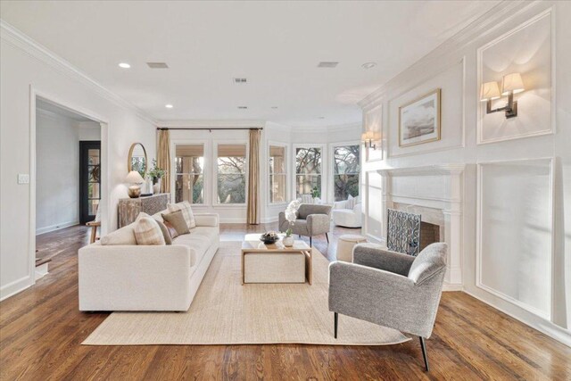 2610 Allston Ln, Austin, TX 78746 - living area with ornamental molding, wood finished floors, a fireplace, and recessed lighting