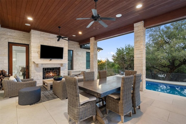 4229 Verano Dr, Austin, TX 78735 - view of patio / terrace featuring an outdoor stone fireplace and a ceiling fan