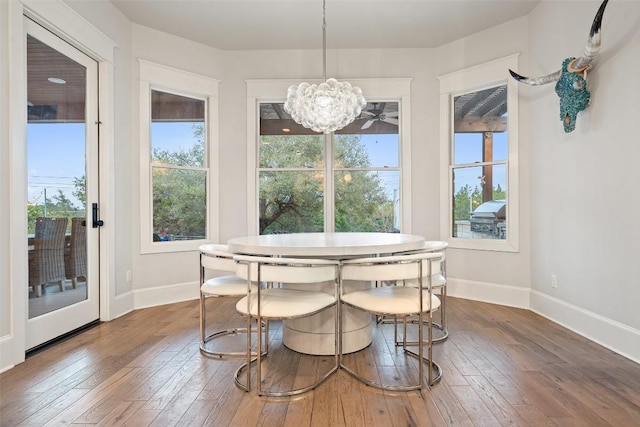 4229 Verano Dr, Austin, TX 78735 - dining area featuring healthy amount of natural light, wood-type flooring, and a chandelier