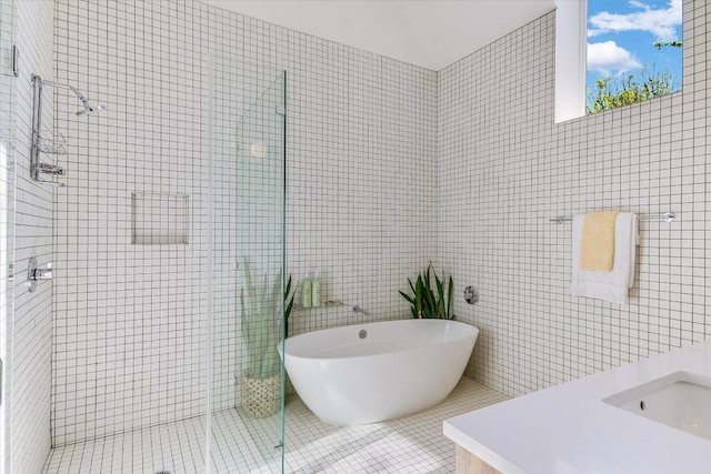2010 Goodrich Ave Unit 8A, Austin, TX 78704 - bathroom featuring a shower stall, tile walls, tile patterned floors, and a soaking tub