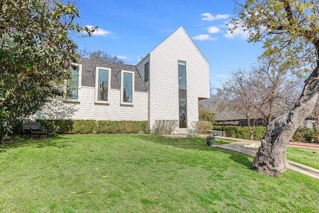 2010 Goodrich Ave Unit 8A, Austin, TX 78704 - view of side of home with a lawn and roof with shingles