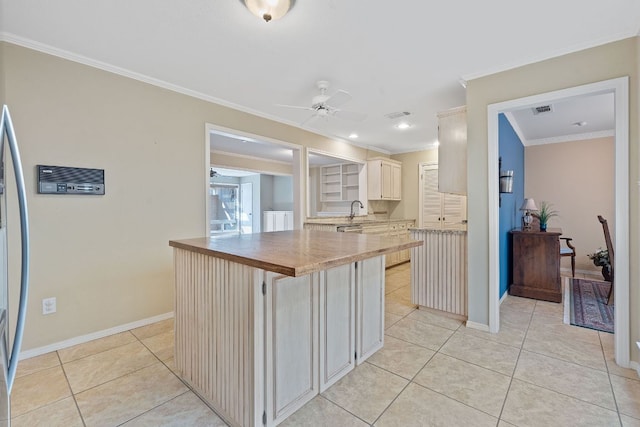 8113 W Ct, Austin, TX 78759 - kitchen with crown molding, a ceiling fan, light tile patterned flooring, baseboards, and a sink
