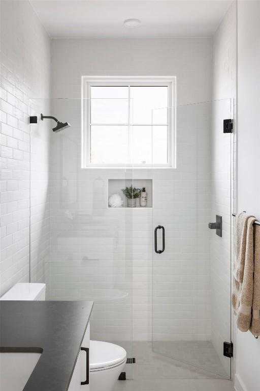 3607 Garden Villa Ln, Austin, TX 78704 - full bathroom with vanity, a stall shower, plenty of natural light, and tile walls