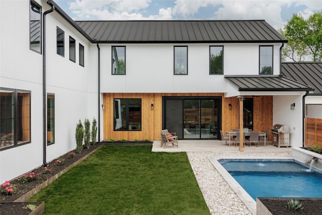 3607 Garden Villa Ln, Austin, TX 78704 - rear view of house featuring a standing seam roof, a metal roof, a patio area, a lawn, and an outdoor pool