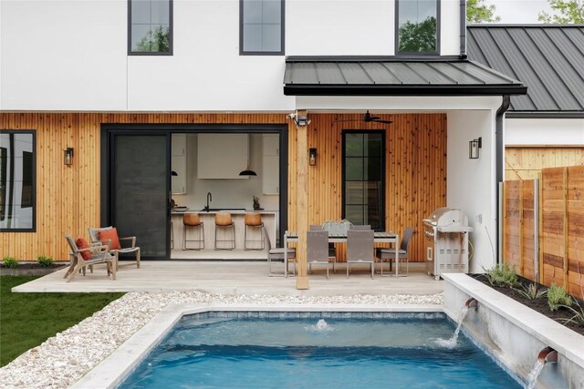 3607 Garden Villa Ln, Austin, TX 78704 - rear view of house with a metal roof, an outdoor pool, and a standing seam roof