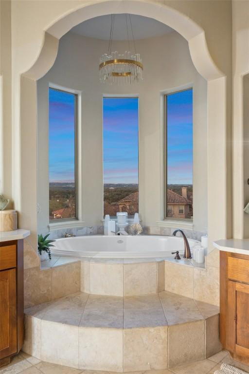 11901 Preserve Vista Ter, Austin, TX 78738 - full bath featuring vanity, a garden tub, and a chandelier