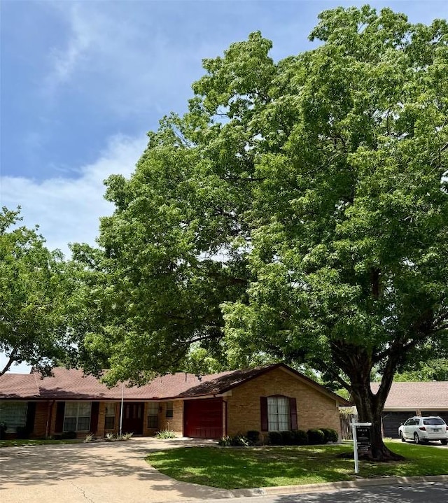 1908 Running Brook Dr, Austin, TX 78723 - ranch-style house with a garage, driveway, a front yard, and brick siding