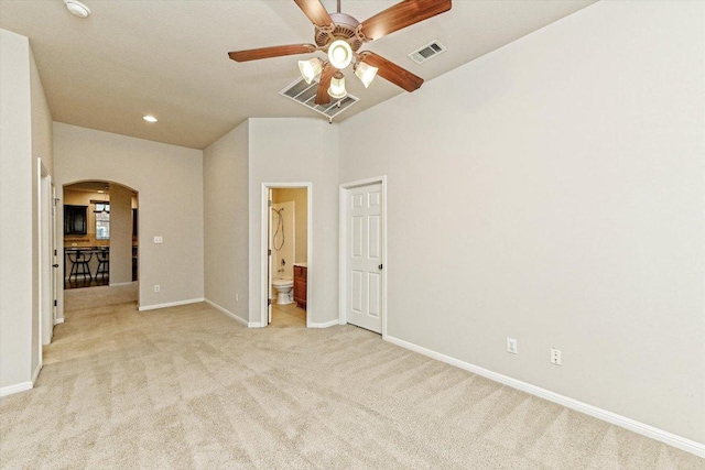 412 Madisons Way, Cedar Park, TX 78613 - unfurnished bedroom with arched walkways, light colored carpet, baseboards, connected bathroom, and recessed lighting