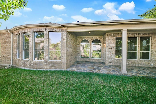 412 Madisons Way, Cedar Park, TX 78613 - property entrance with a lawn, brick siding, and a patio