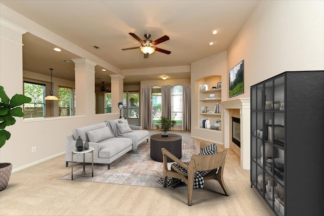 412 Madisons Way, Cedar Park, TX 78613 - living area with ceiling fan, light carpet, built in features, ornate columns, and a glass covered fireplace