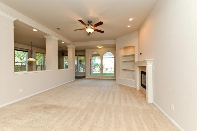 412 Madisons Way, Cedar Park, TX 78613 - unfurnished living room with ceiling fan, light carpet, built in features, a fireplace, and baseboards