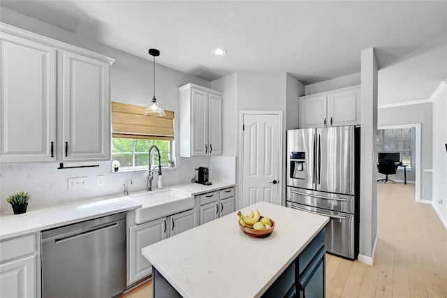 2004 Wood Glen Dr, Round Rock, TX 78681 - kitchen featuring appliances with stainless steel finishes, light wood-type flooring, backsplash, white cabinetry, and recessed lighting