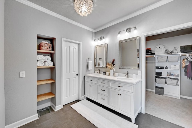 2004 Wood Glen Dr, Round Rock, TX 78681 - bathroom featuring double vanity, ornamental molding, and a spacious closet