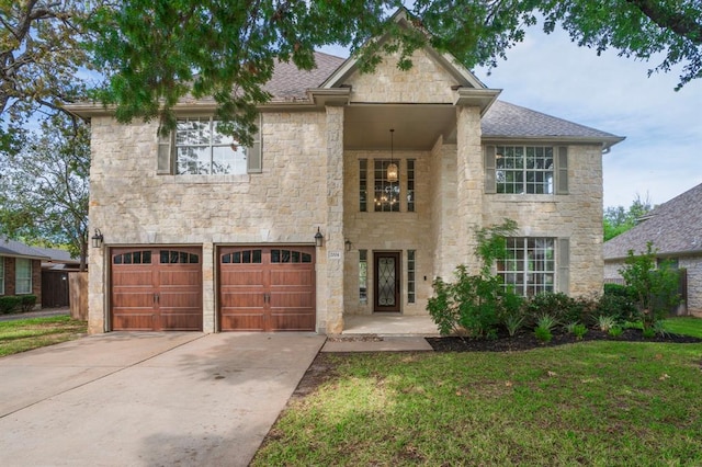2004 Wood Glen Dr, Round Rock, TX 78681 - view of front of house featuring stone siding, an attached garage, concrete driveway, and a front yard