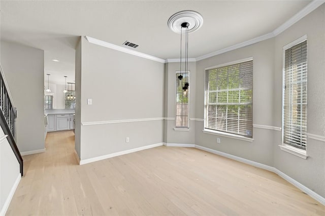 2004 Wood Glen Dr, Round Rock, TX 78681 - unfurnished dining area featuring light wood-style floors, ornamental molding, and stairs