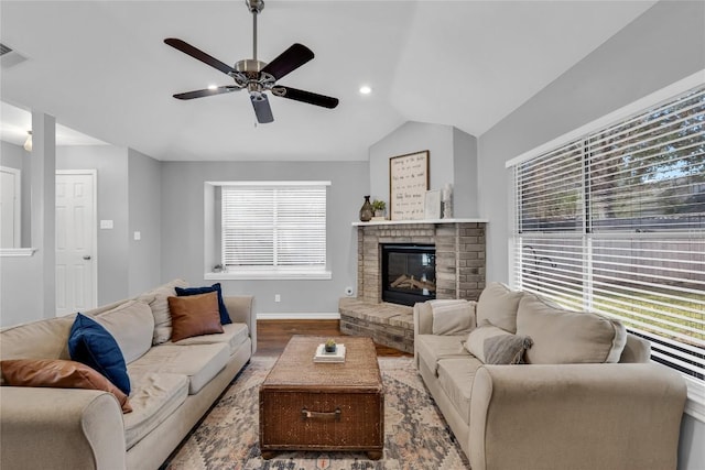 704 Firethorn Ln, Round Rock, TX 78664 - living area with wood finished floors, a ceiling fan, lofted ceiling, healthy amount of natural light, and a brick fireplace