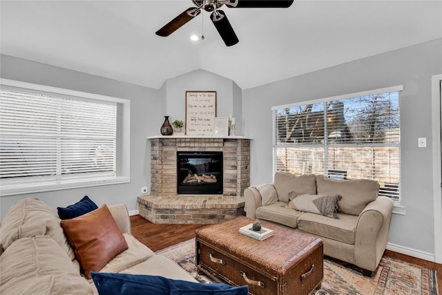 704 Firethorn Ln, Round Rock, TX 78664 - living area with a ceiling fan, baseboards, wood finished floors, lofted ceiling, and a fireplace