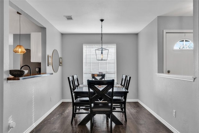 704 Firethorn Ln, Round Rock, TX 78664 - dining space with dark wood-style floors and baseboards