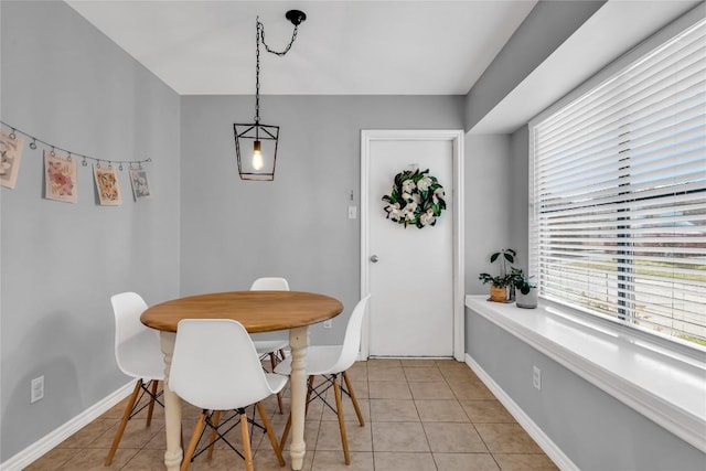 704 Firethorn Ln, Round Rock, TX 78664 - dining area with healthy amount of natural light, light tile patterned floors, and baseboards