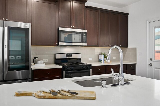 5400 Golden Canary Ln Unit 49, Austin, TX 78723 - kitchen featuring light countertops, stainless steel appliances, and dark brown cabinets